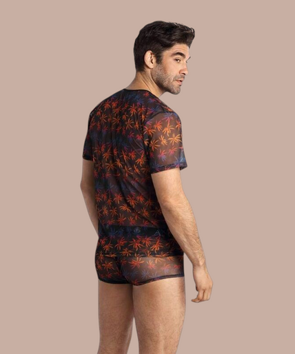 Anais Men – Chill T-Shirt M Pleasurements Anais Men Chill T-shirt met transparante stof en kleurrijk palmbladpatroon gedragen door een model