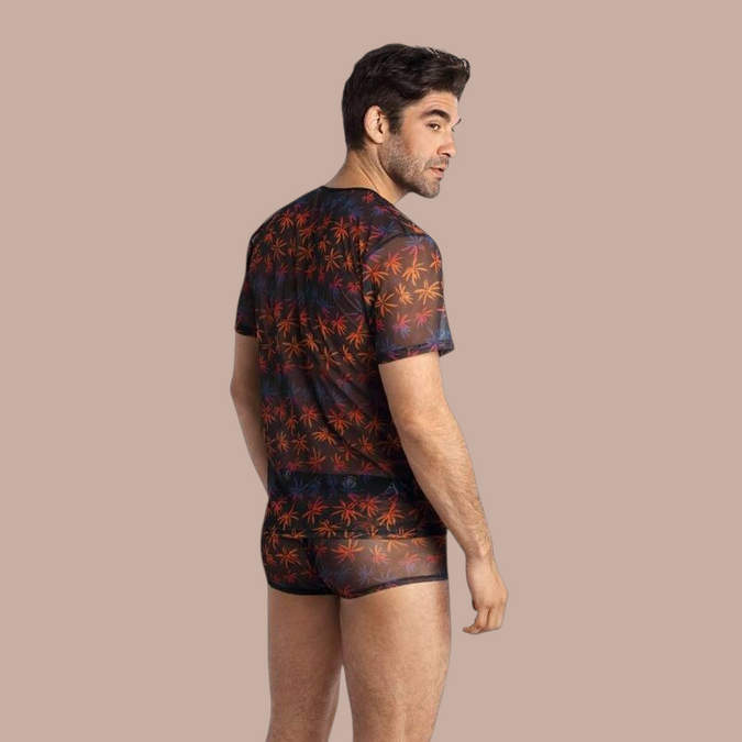 Pleasurements Anais Men Chill T-shirt in zwart transparant mesh met kleurrijk palmboompatroon gedragen door model