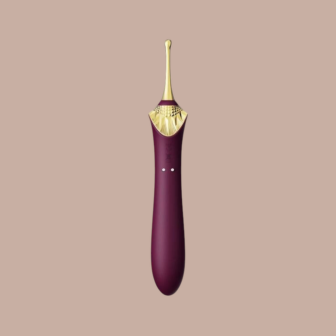 Paarse Zalo Bess 2 clitorisstimulator van Pleasurements met een luxe gouden detail en siliconen afwerking.