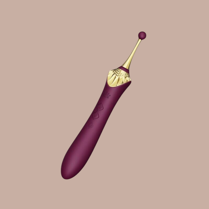 Pleasurements Zalo Bess 2 paarse clitorisstimulator van siliconen met gouden details en verwarmingsfunctie