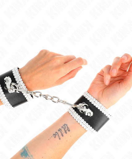 KINK - BLACK WRIST RESTRAINTS WITH WHITE DECORATE LACE ADJSUTABLE 20-23 CM X 5.5 CM KINK - BLACK WRIST RESTRAINTS WITH WHITE DECORATE LACE ADJSUTABLE 20-23 CM X 5.5 CM