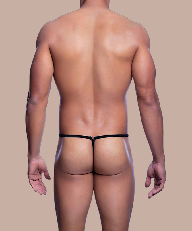 Pleasurements Mob Black Tear zwarte string met minimalistisch ontwerp gedragen door een man op een beige achtergrond