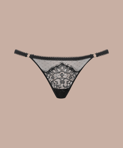 Inspiration Divine black Thong with sheer dotted mesh, floral lace and narrow side straps, front view on model.