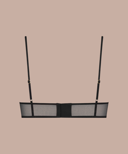 Model draagt de zwarte Scandale L'Amoureuse korset-bh met transparante mesh-details en een verfijnd silhouet.
