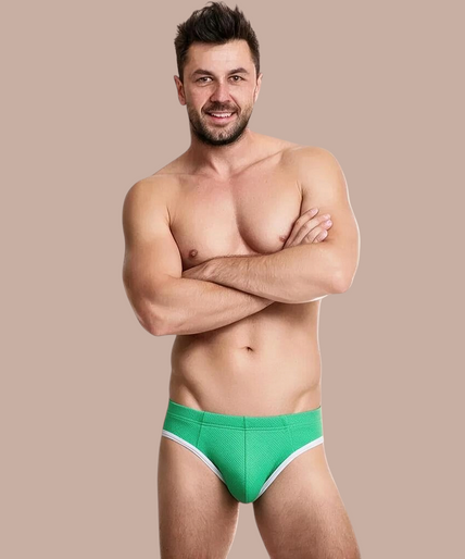Man draagt een groene BURN 022 slip van Pleasurements met witte randen, voor een stijlvolle en comfortabele look.