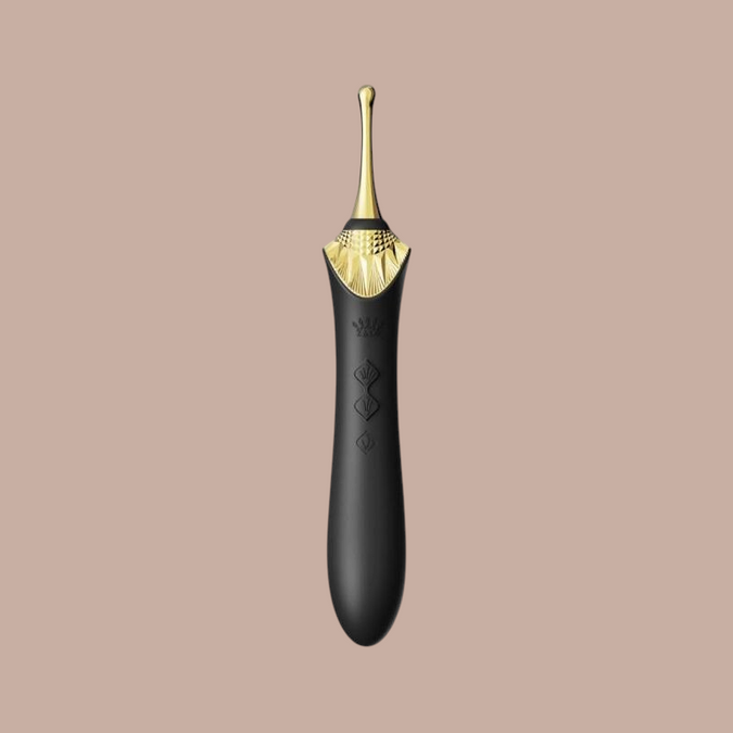 Zalo Bess 2 clitoral massager van Pleasurements in zwart silicone met gouden accenten en verwarmingsfunctie
