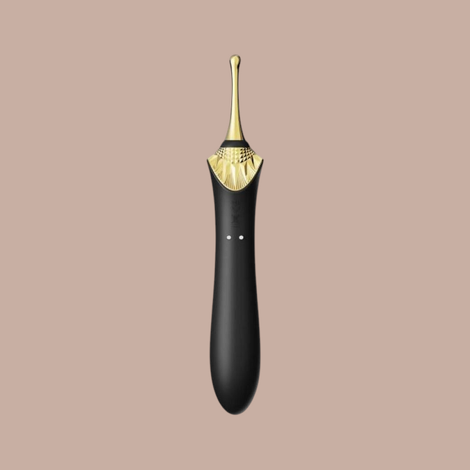 Pleasurements Zalo Bess 2 clitorale massager in zwart silicone met gouden accenten en verwarmingsfunctie.