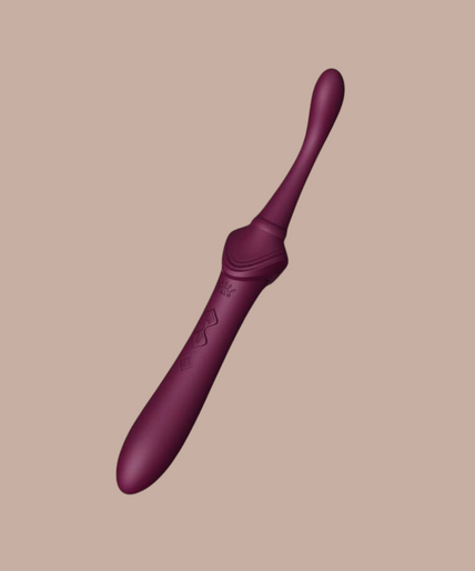Pleasurements Zalo Bess 2 paarse clitorisstimulator van siliconen met verwisselbare opzetstukken en gouden details.